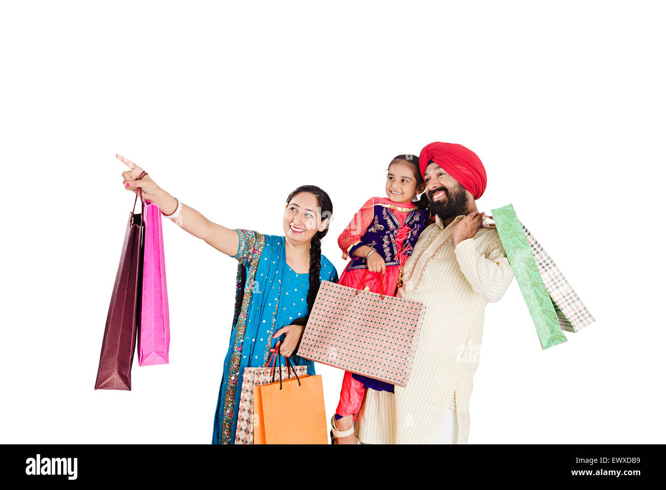Indian Punjabi genitori e figlia shopping puntare il dito Foto Stock
