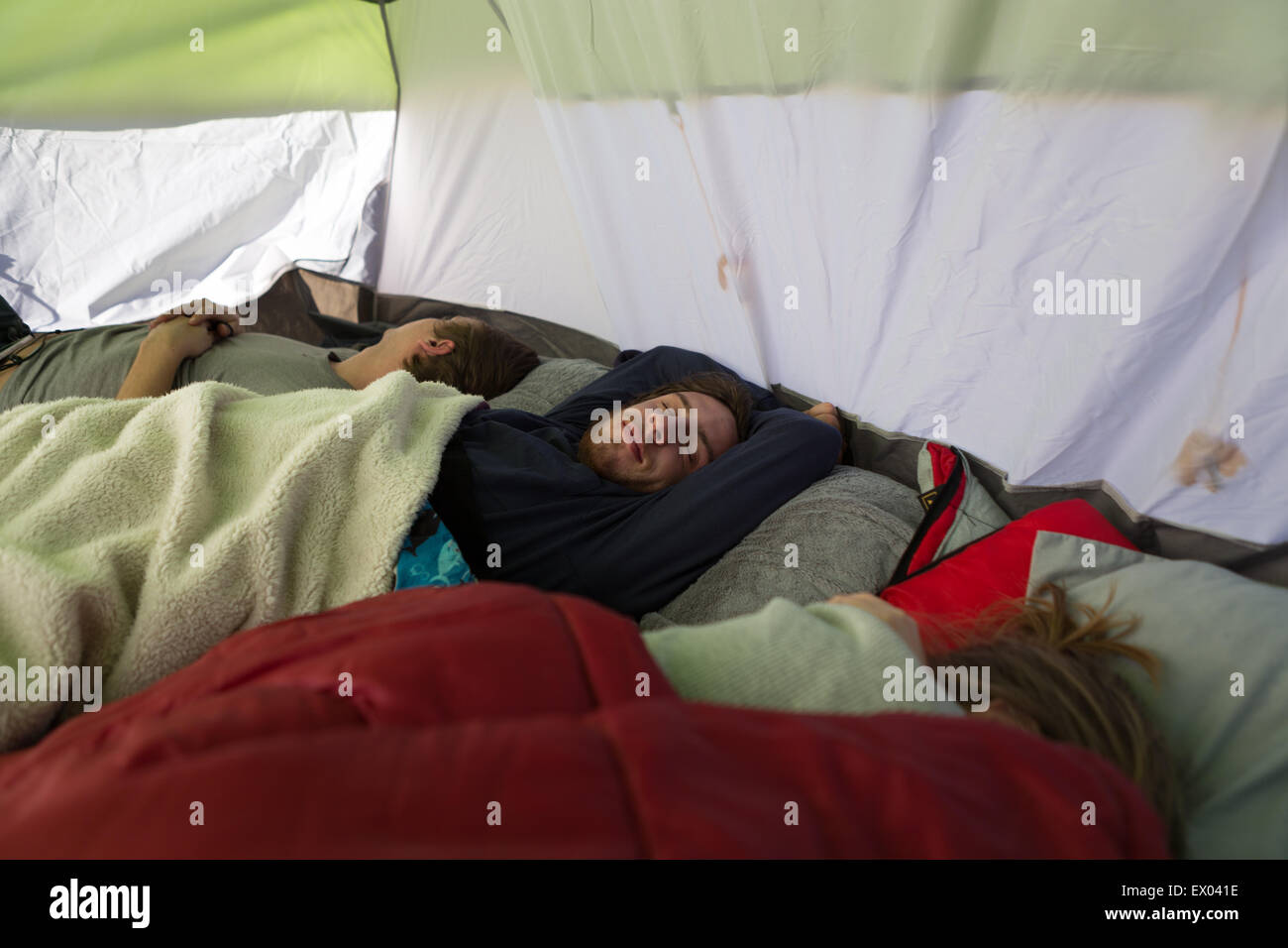 Tre giovani amici adulti addormentato in tenda Foto Stock