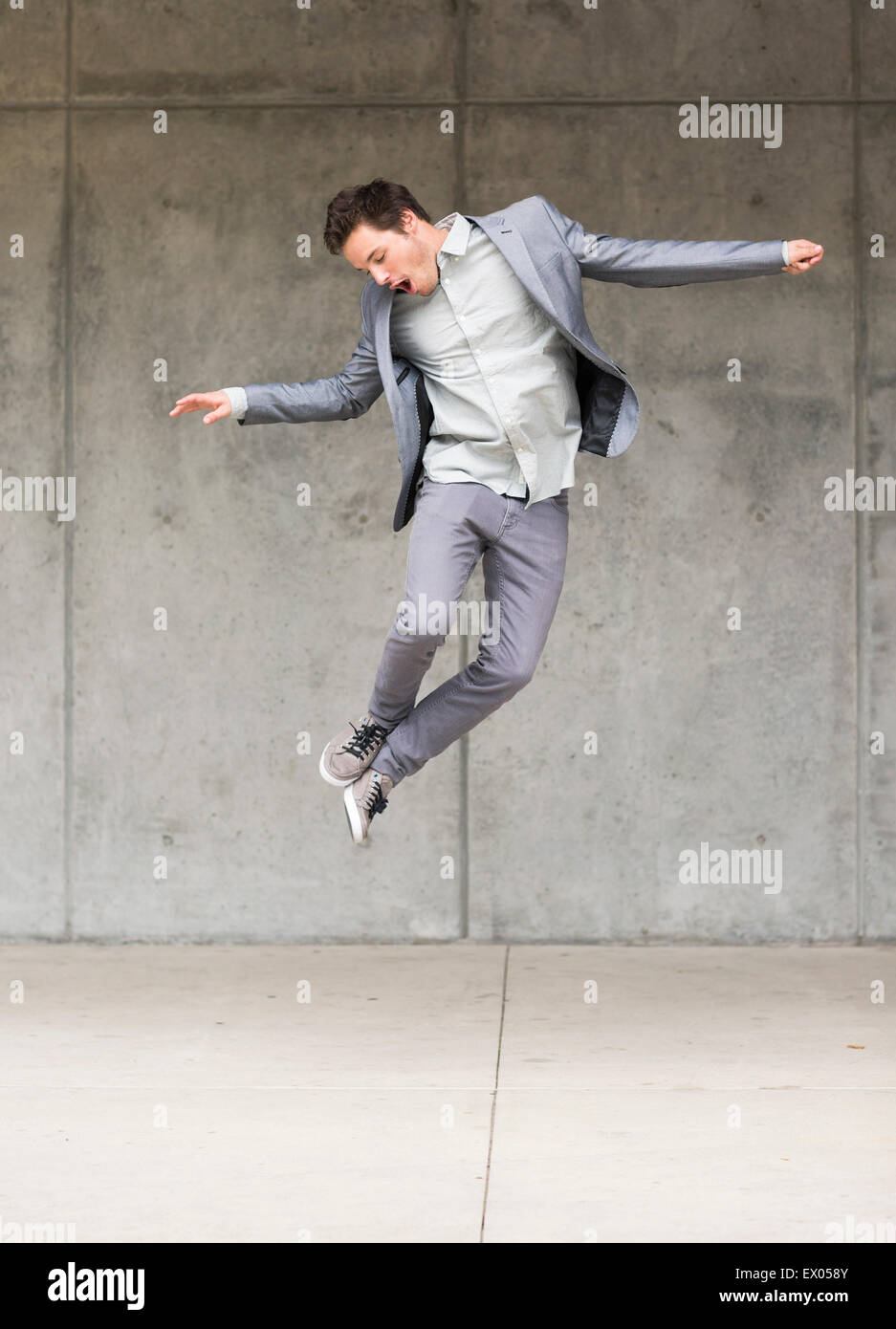 Businessman jumping metà aria Foto Stock
