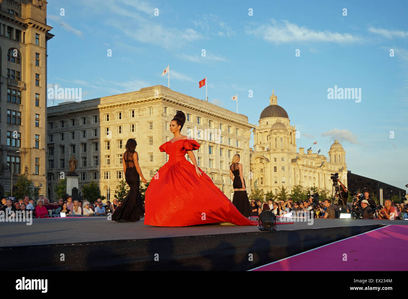 Liverpool, Regno Unito. 04 Luglio, 2015. Un nuovo Guinness World Record per la maggior parte delle persone modellazione su una passerella è stato rotto in Liverpool la sera di sabato 4 luglio, 2015. Il vecchio record era detenuto da Città del Messico con 3,083 persone - Liverpool è di nuovo record è stato 3,651 persone su una passerella. L'evento ha avuto luogo presso il Pier Head , Liverpool e fu visto da migliaia di persone sotto il sole con la Queen Mary 2 ormeggiato in background. Credito: Pak Hung Chan/Alamy Live News Foto Stock