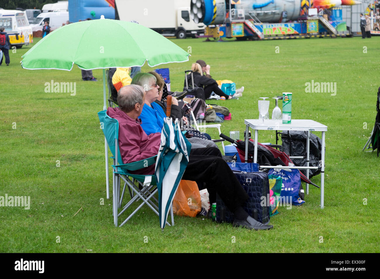 Famiglia picnic estivo Heavy Rain ombrelloni Inghilterra Foto Stock