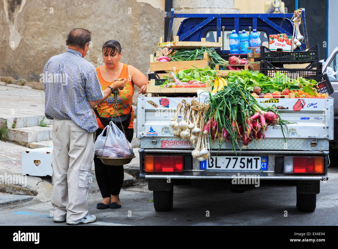 Donna acquistare frutta e verdura fresca da un venditore ambulante, Sicilia, Italia Foto Stock