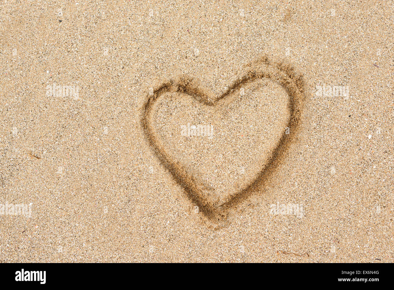 Primo piano della forma di cuore il disegno su una spiaggia di sabbia Foto Stock