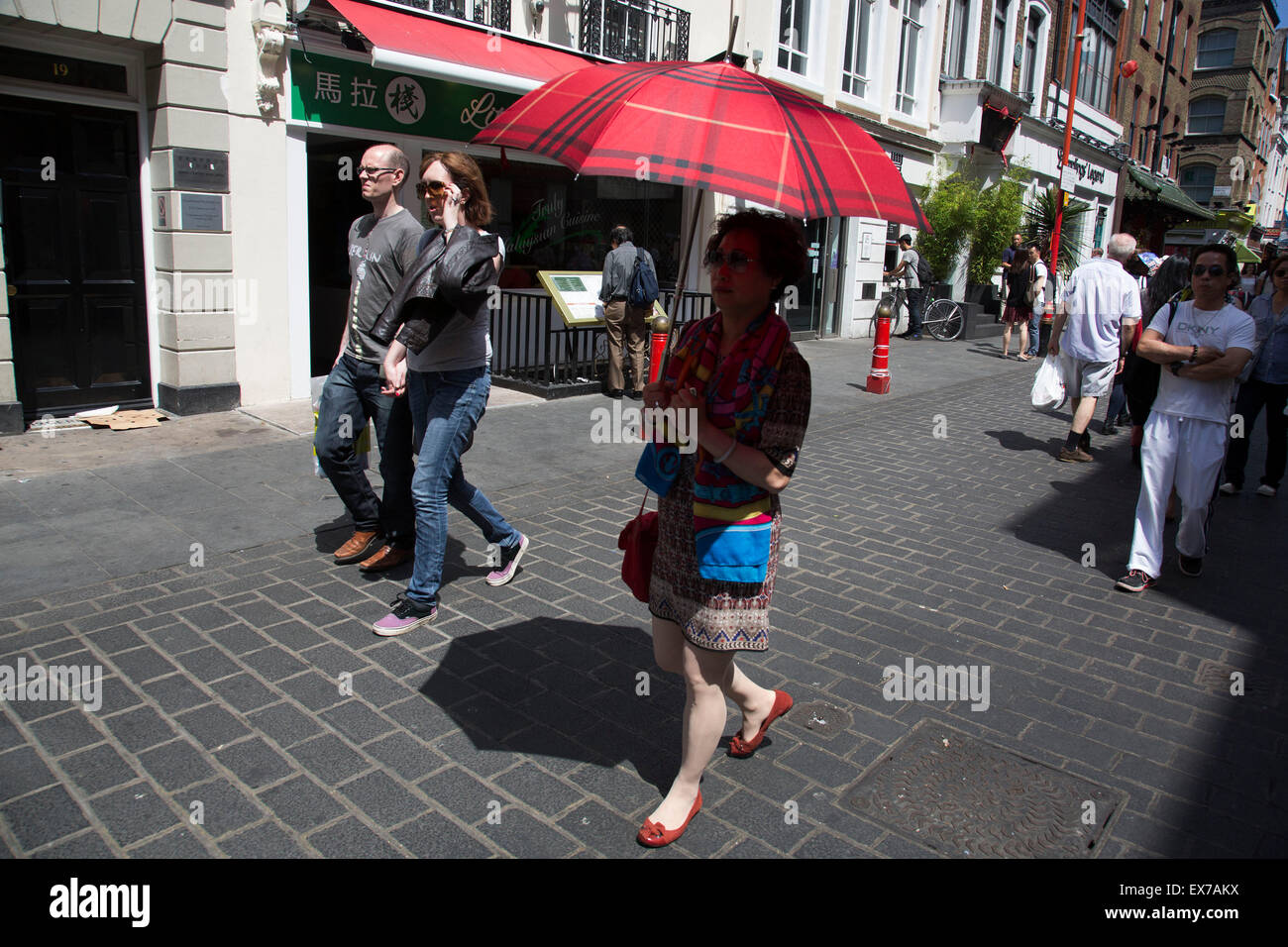 Estate a Londra, Inghilterra, Regno Unito. In scena a Chinatown. La presente Chinatown si trova nella zona di Soho che occupa l'area in e attorno a Gerrard Street. Esso contiene un certo numero di ristoranti cinesi, panifici, supermercati, negozi di souvenir e altri cinese-gestione delle imprese ed è di per sé un importante destinazione turistica. Foto Stock