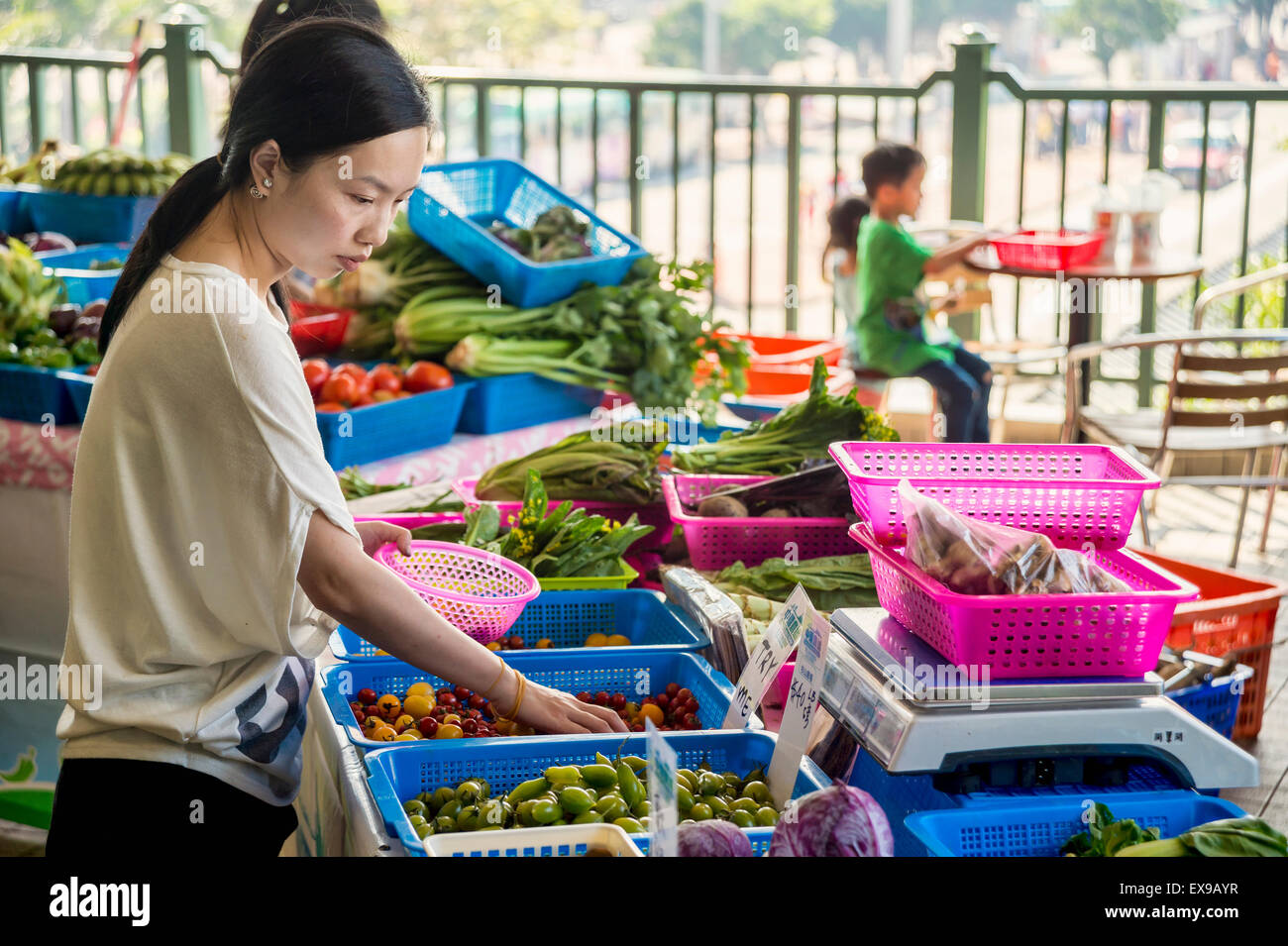 Donna asiatica al di agricoltori biologici nel mercato di Hong Kong al Molo Star Ferry Foto Stock