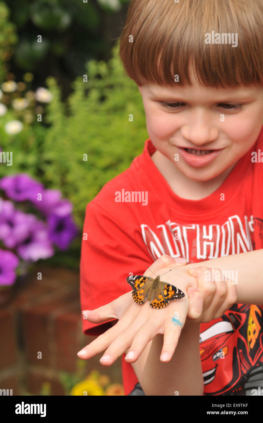 Un ragazzo con un dipinto di lady butterfly Foto Stock