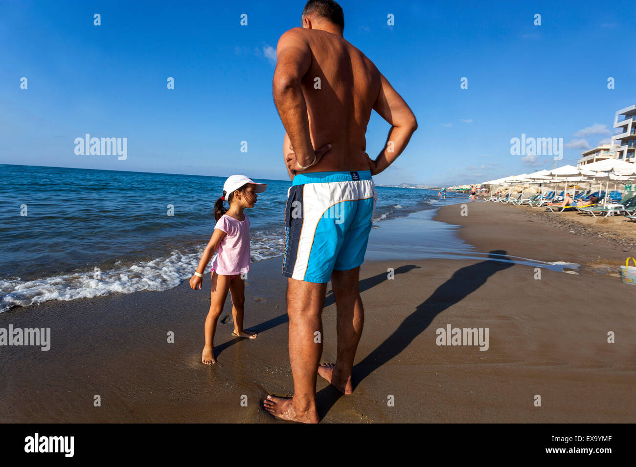 Uomo con bambino, bambina su una spiaggia di Rethymno, Creta, Grecia vacanzieri Foto Stock
