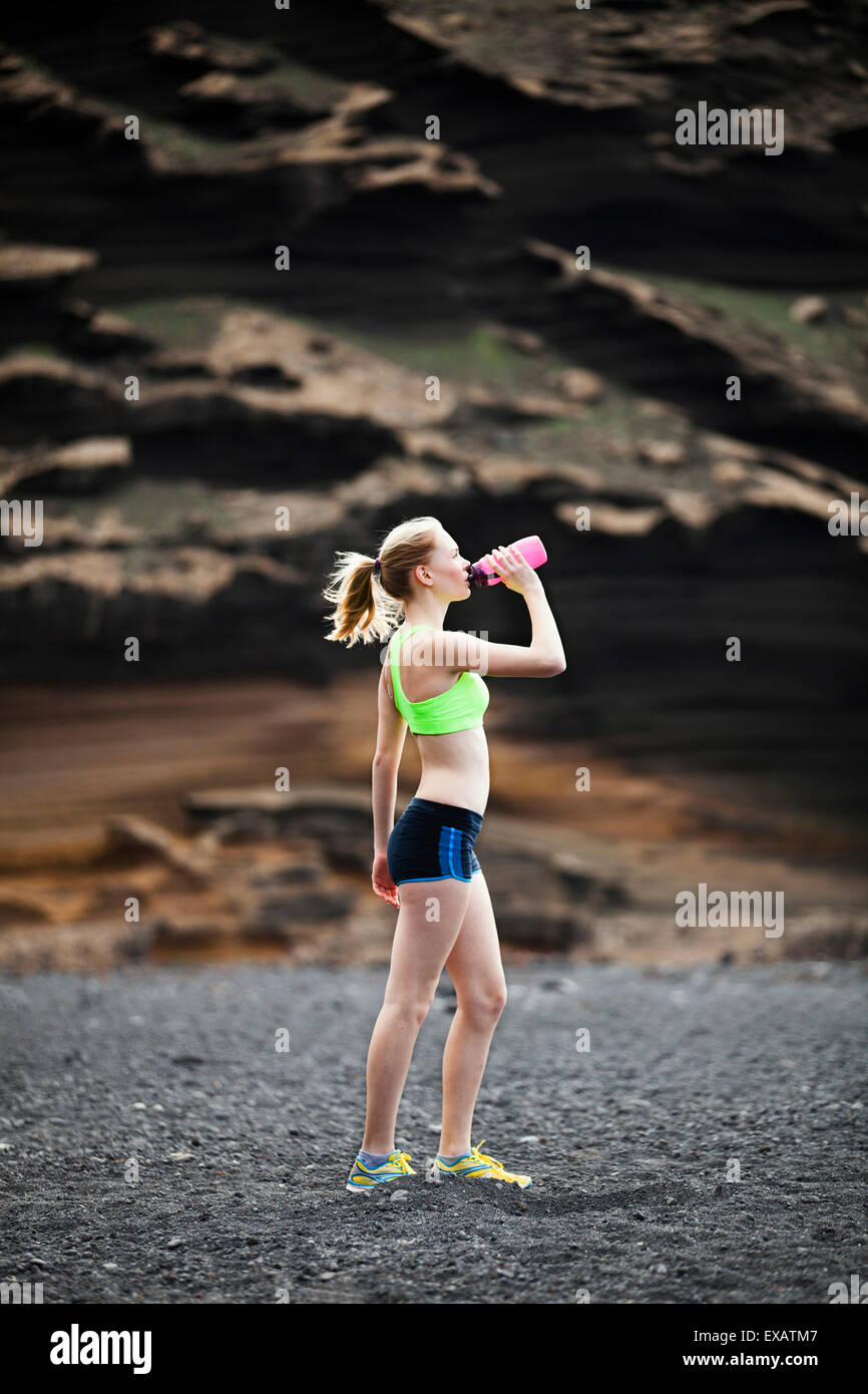 Donna acqua potabile, acceso, jogging Foto Stock
