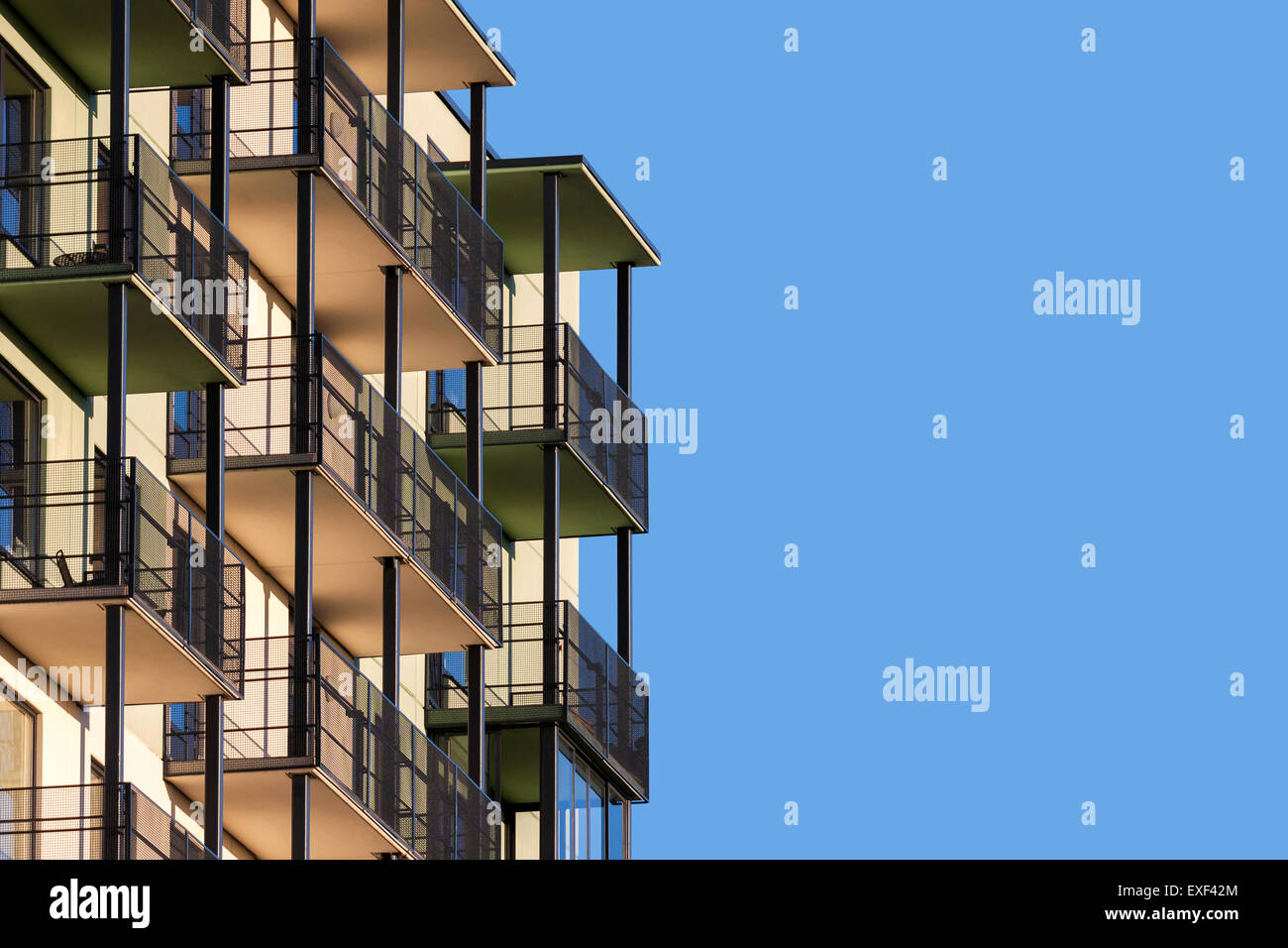 Moderno edificio di appartamenti con balconi contro il cielo blu per il testo pubblicitario Foto Stock