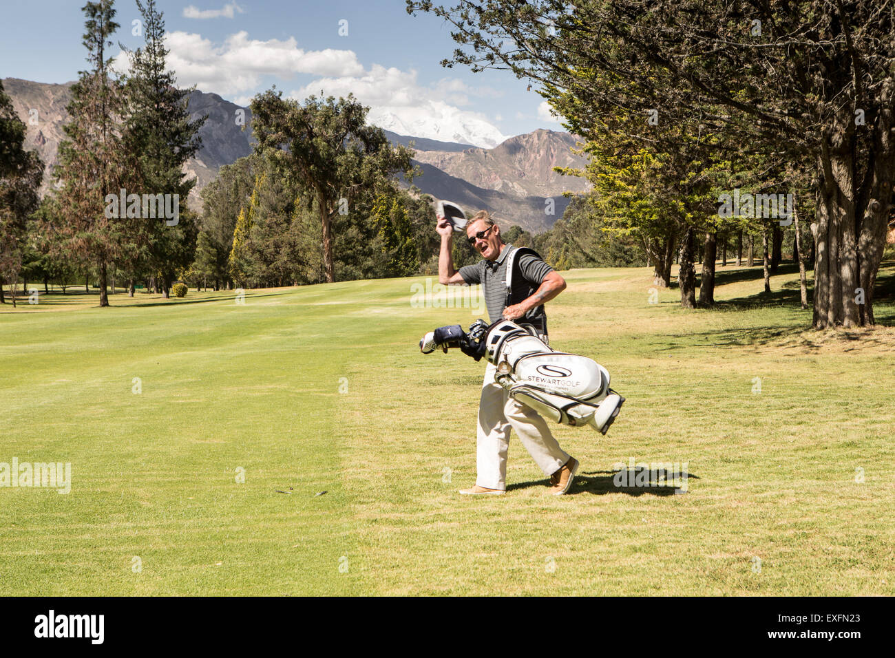 Uomo con i golf club in corso Foto Stock