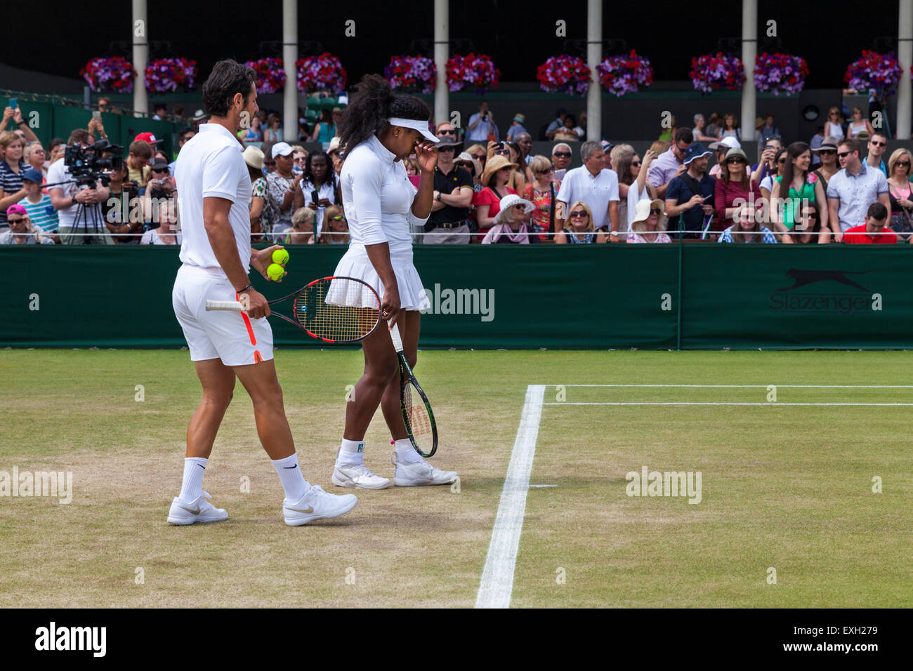 Serena Williams si riscalda per giocare aiutato dal coach Patrick Mouratoglou, durante i campionati di Wimbledon 2015 Foto Stock