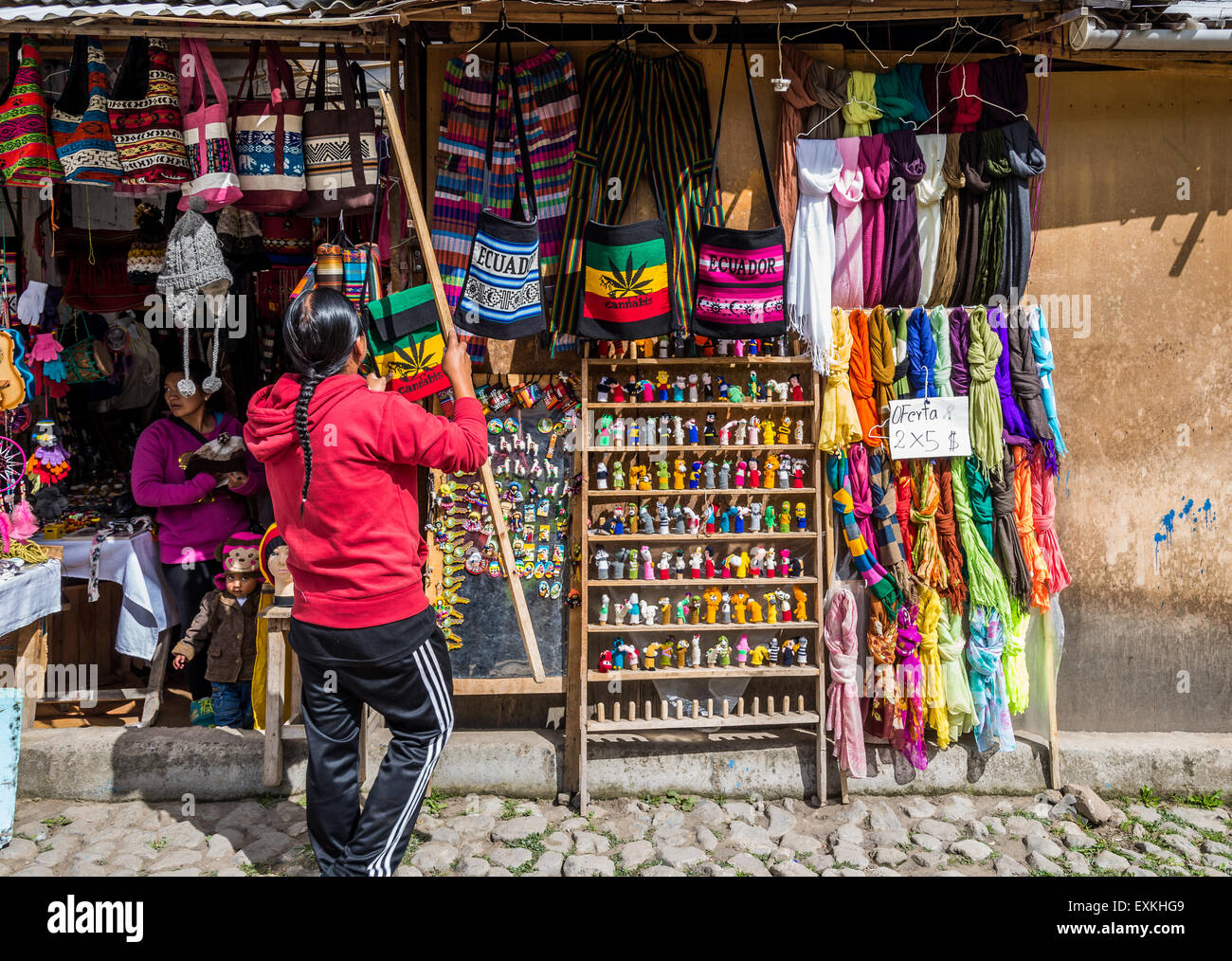 Negoziante la visualizzazione di mercanzie presso un negozio di souvenirs. Otavalo, Ecuador. Foto Stock