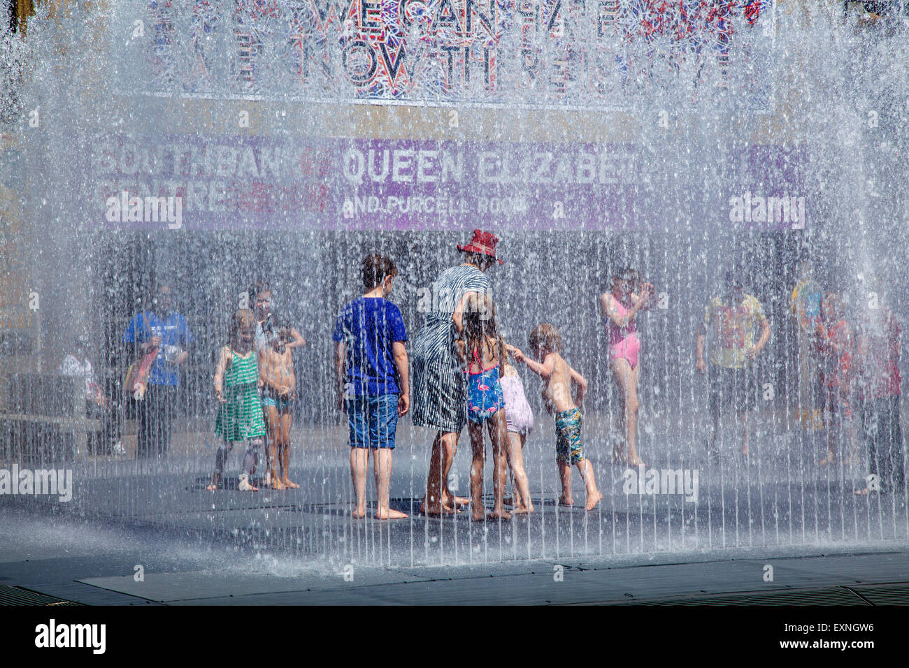 Bambini che giocano in acqua delle fontane su una giornata d'estate, Southbank, Londra, Inghilterra Foto Stock