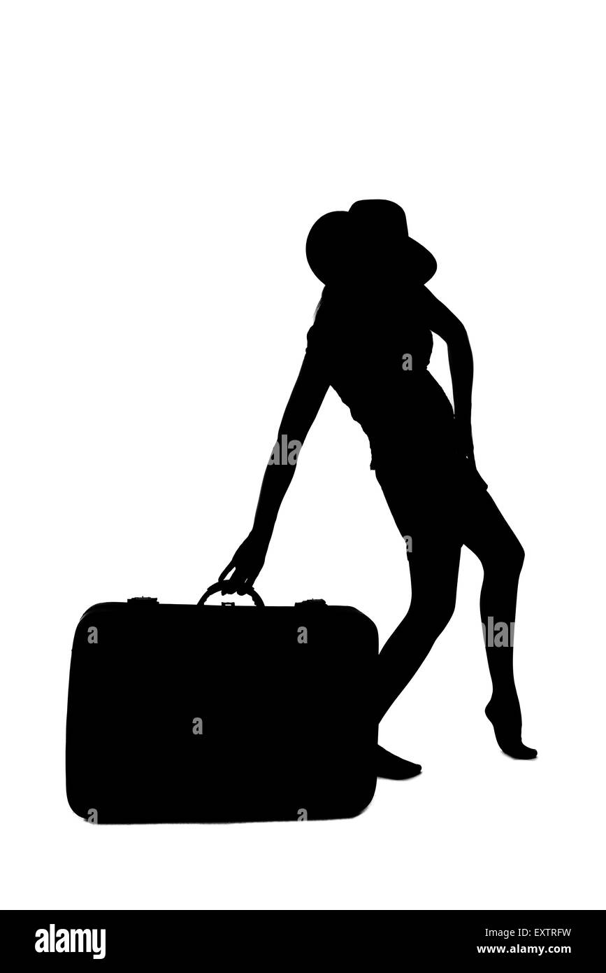 Silhouette di donna - tenendo un bagaglio Foto Stock