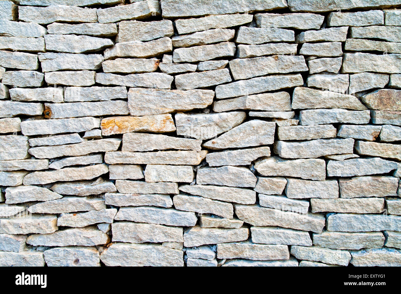 Muro di pietra sfondo texture mattone il vecchio modello di architettura della superficie del materiale calcestruzzo marrone rock ruvido cemento bianco nero vinta Foto Stock