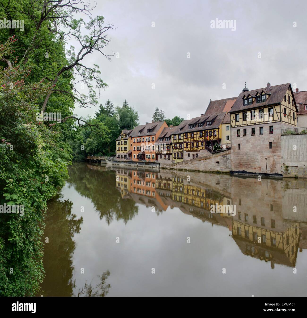 Semi-case con travi di legno accanto al fiume Rednitz in Stein, Franconia, Baviera, Germania Foto Stock