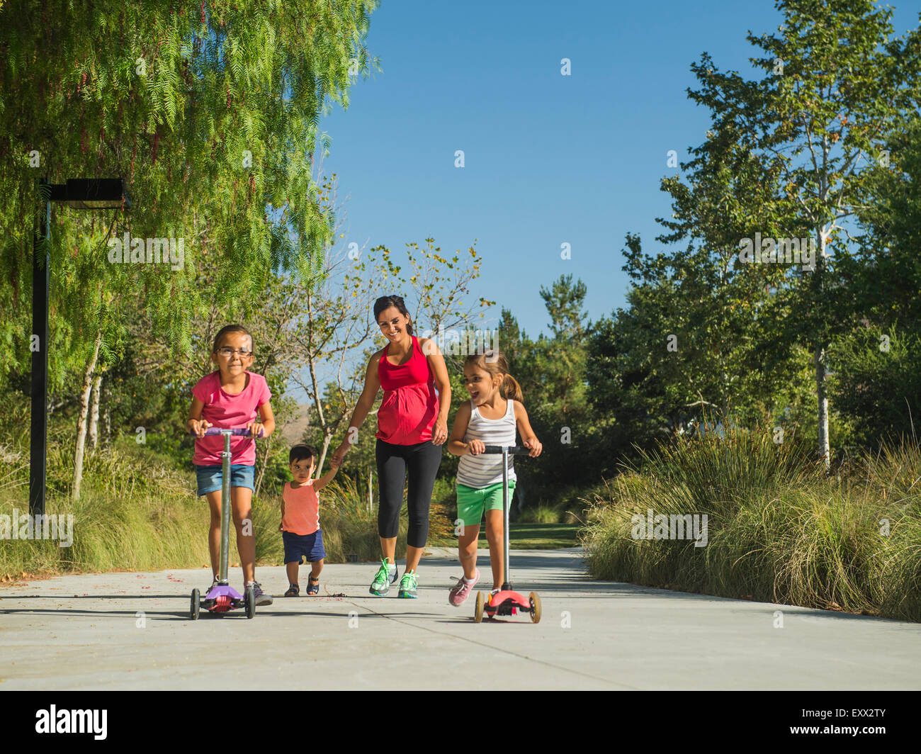 Madre durante la gravidanza e per i bambini (2-3, 6-7, 8-9) passeggiate all'aperto Foto Stock