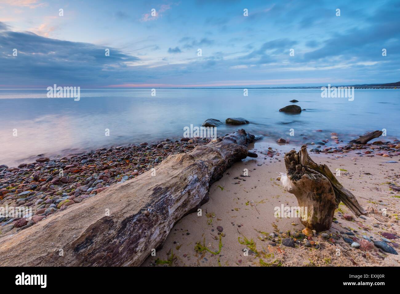 Bellissimo Mare roccioso riva all'alba o al tramonto. Una lunga esposizione paesaggio. Mar baltico vicino a Gdynia in Polonia. Foto Stock