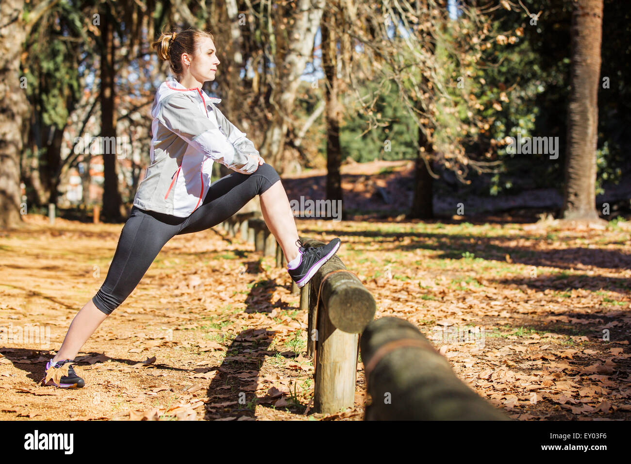 Montare giovane ragazza distesa su un banco di lavoro prima di esercitare in autunno park Foto Stock