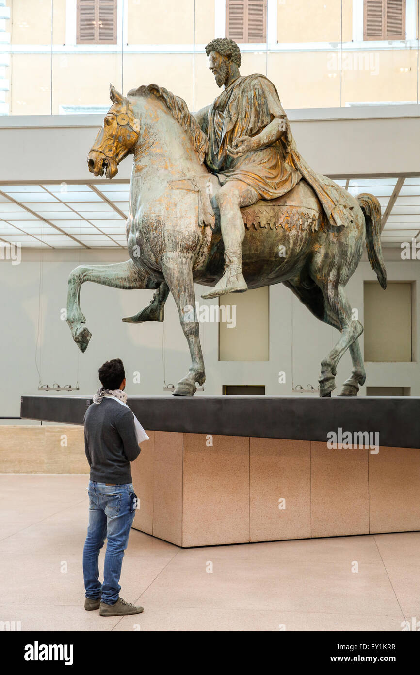 Uomo di ammirare la statua equestre di Marco Aurelio in piedi nel Palazzo dei Conservatori Museo di Roma. Foto Stock