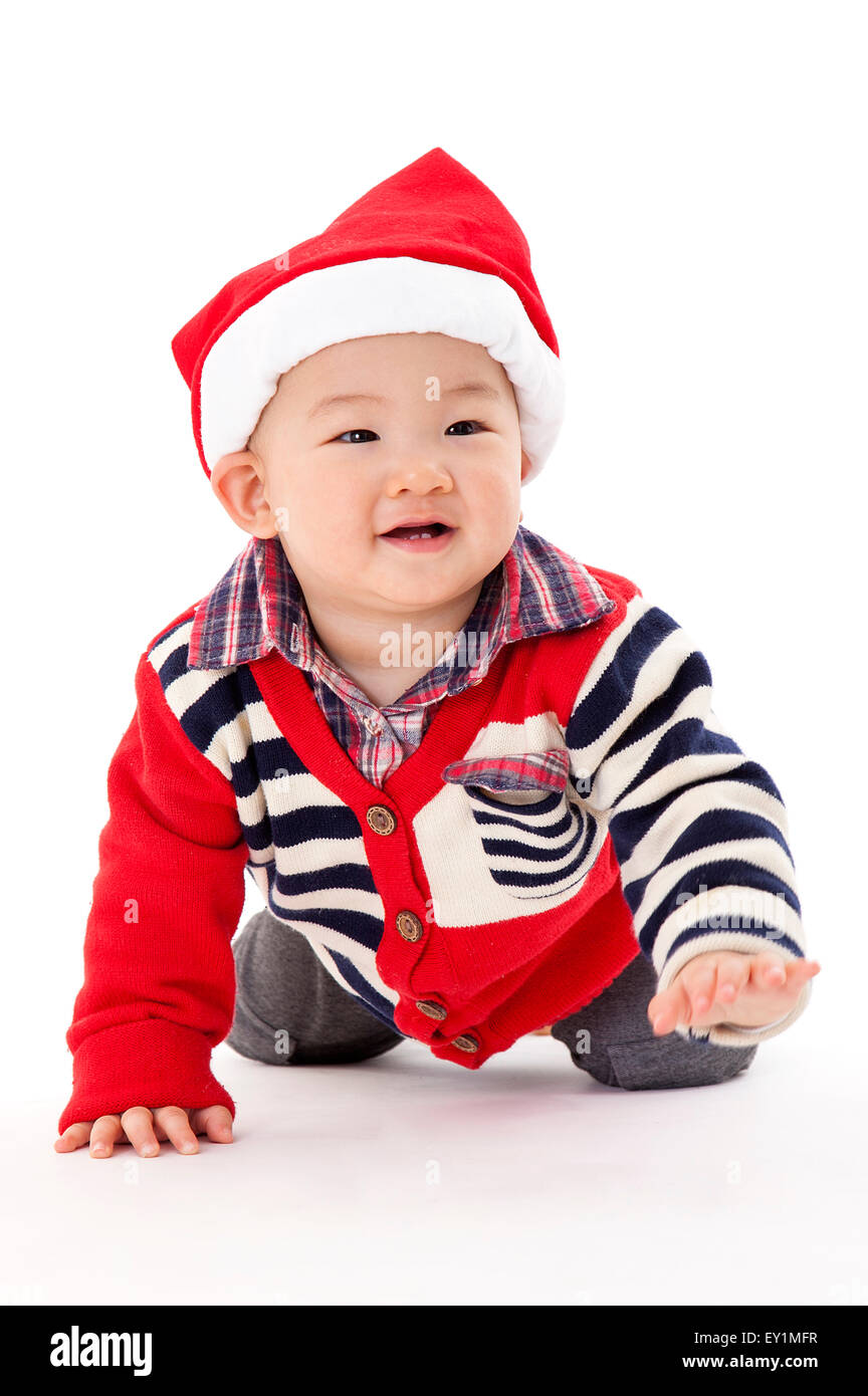 Baby boy indossando Santa hat e sorridente, Foto Stock