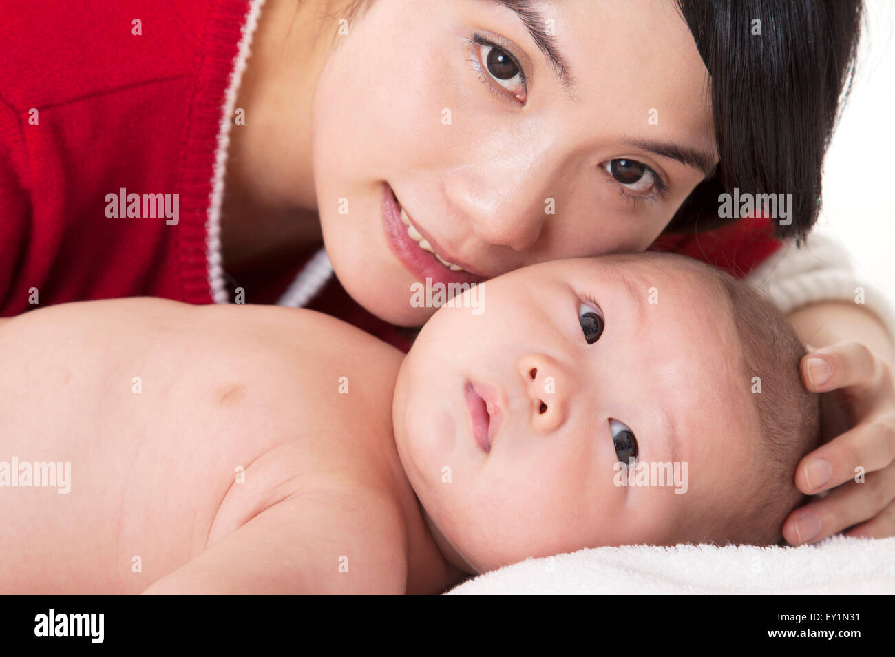 Bambino sdraiato con sua madre e lo sguardo lontano, Foto Stock