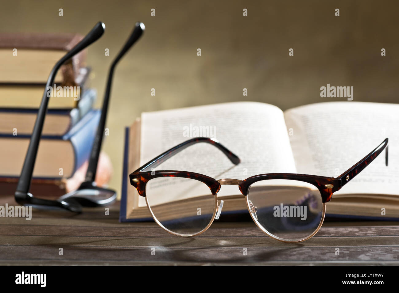 Ancora la vita con gli occhiali e i libri sul tavolo Foto Stock