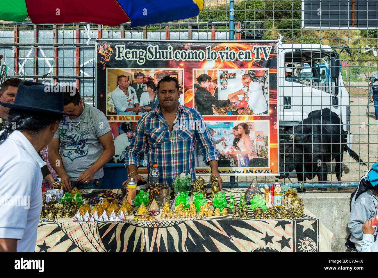 Un uomo di mezza età vendita di Feng Shui gadget al mercato locale. Otavalo, Ecuador. Foto Stock