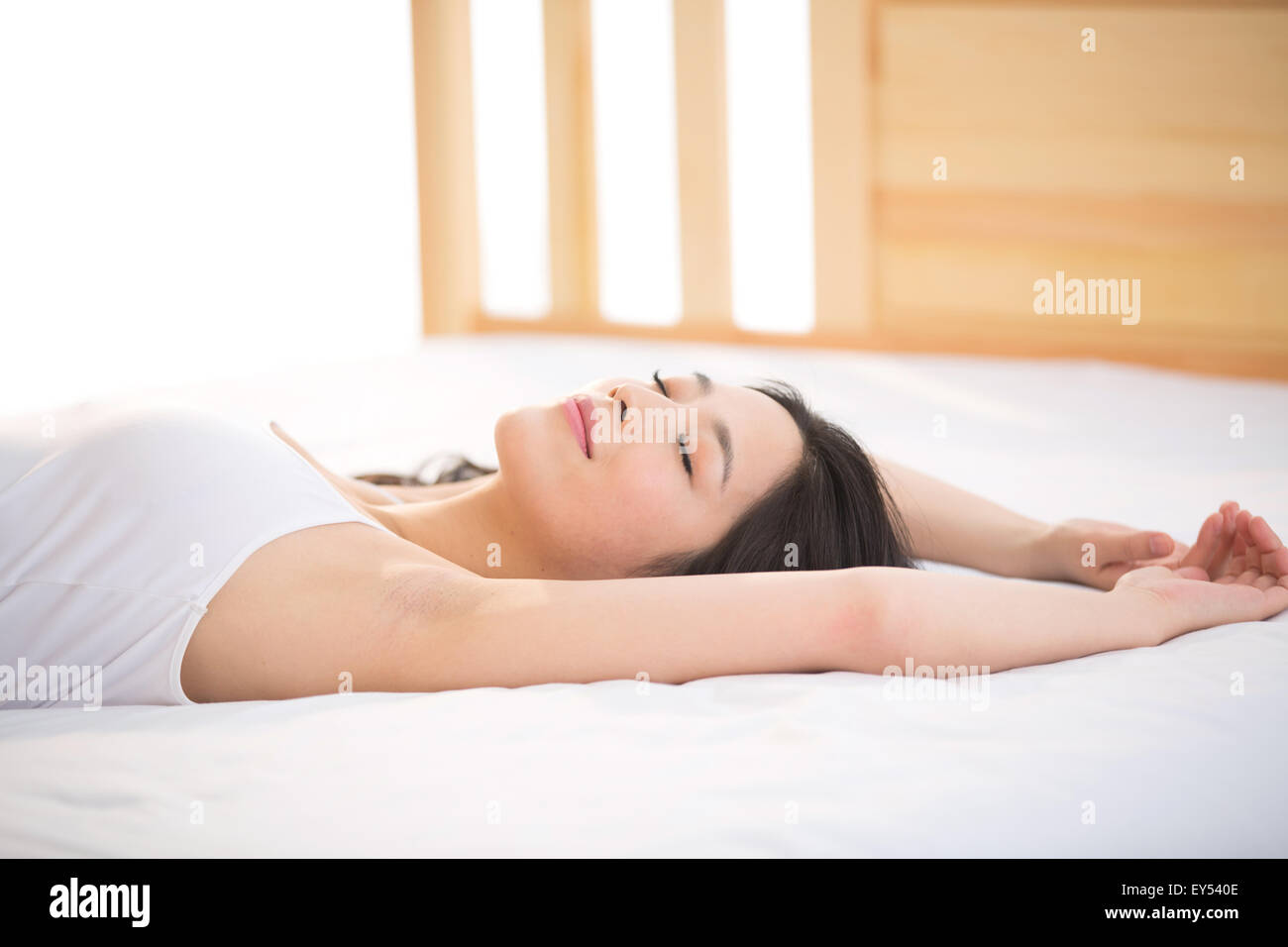 Giovane donna che dorme in camera da letto Foto Stock