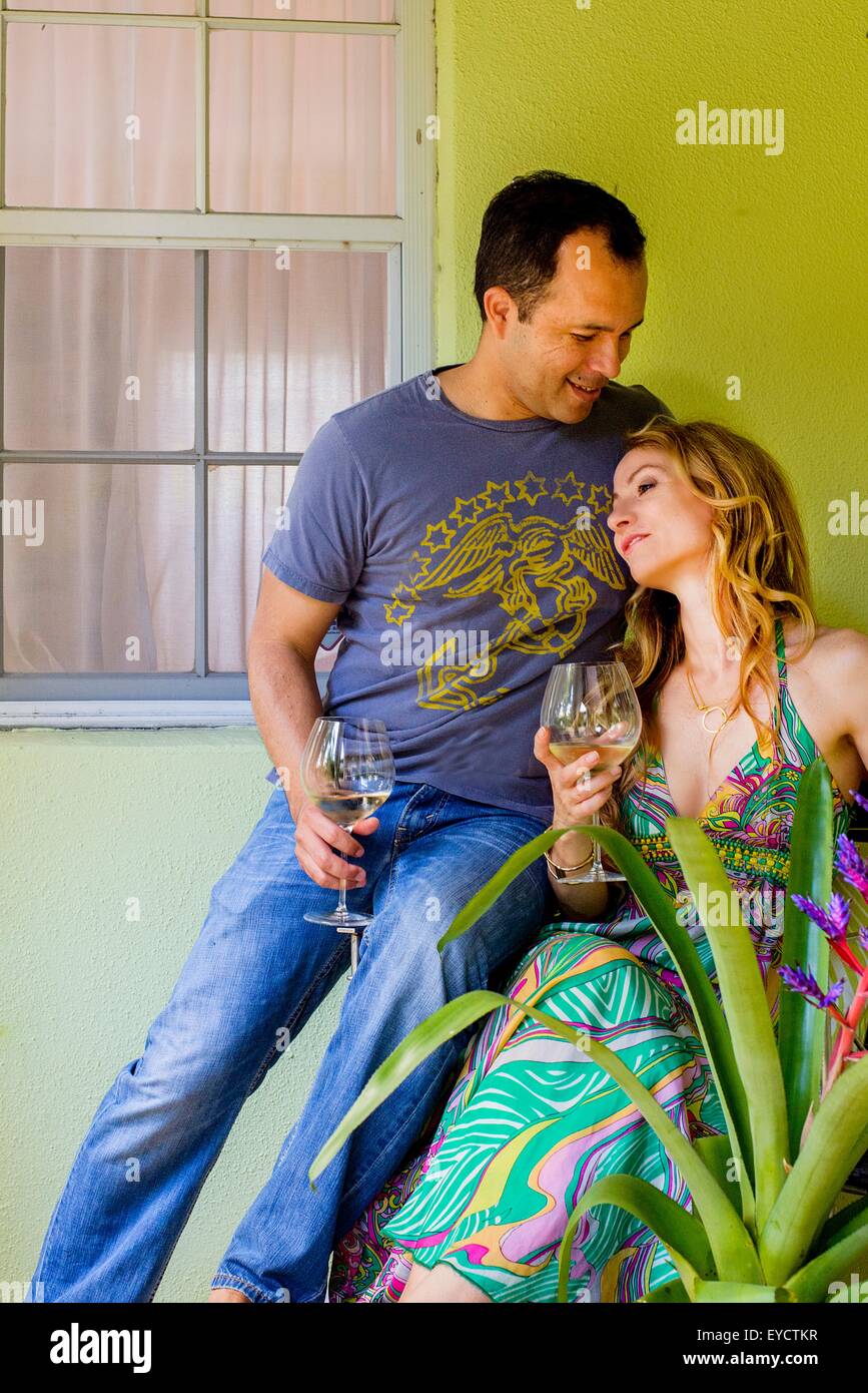 Coppia matura di bere vino bianco nel giardino Veranda Foto Stock