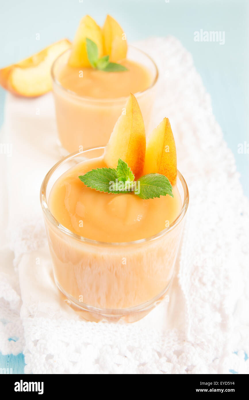 Frullato di pesche dessert con la menta sul tovagliolo bianco Foto Stock