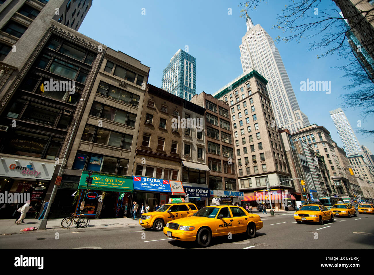 I taxi passano davanti all'Empire State Building, Manhattan, New York, Stati Uniti d'America Foto Stock