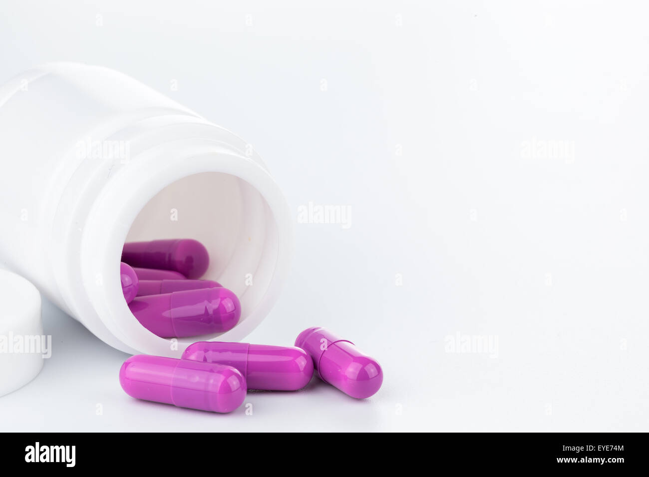Viola pillole una pillola bottiglia su sfondo bianco (isolato) Foto Stock
