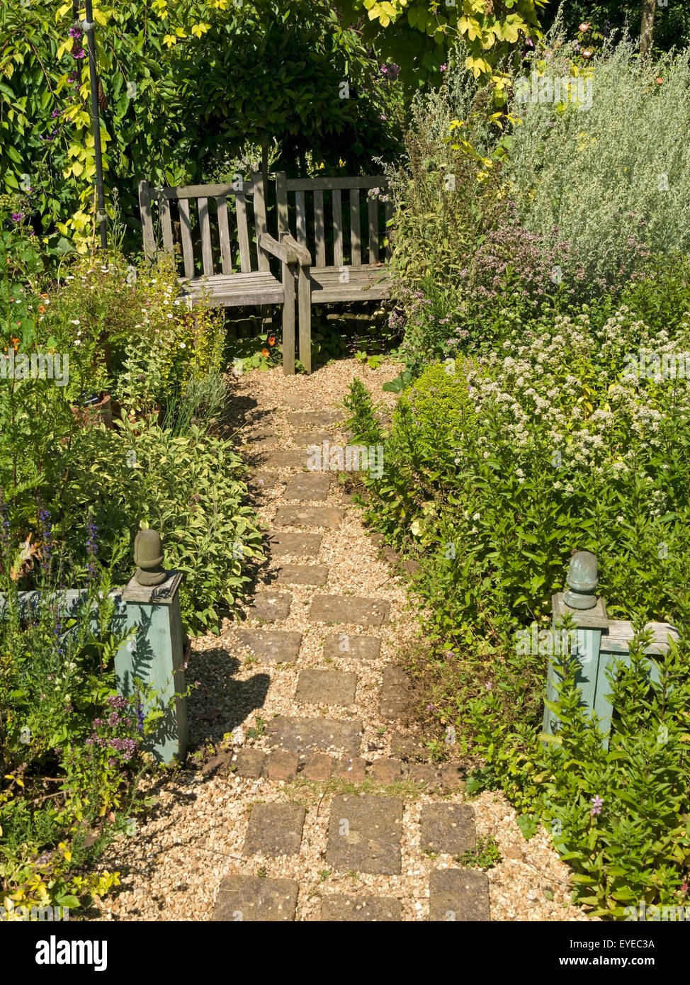 Piccolo cottage inglese con giardino pavimentato e sentiero di ghiaia, confini e giardino in legno posti, Barnsdale Gardens, Rutland, England, Regno Unito Foto Stock
