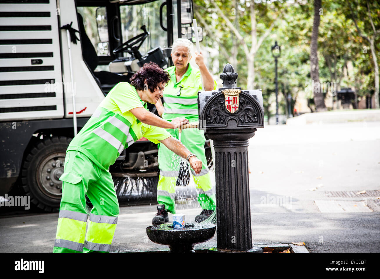 Persone di bere acqua da un rubinetto di strada, Barcellona, Spagna Foto Stock