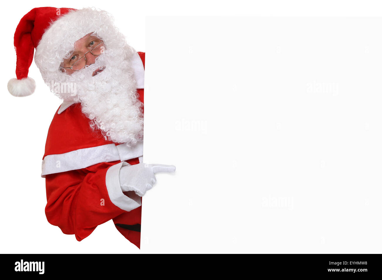 Santa Claus puntando sul Natale a vuoto banner con copyspace per il proprio testo Foto Stock