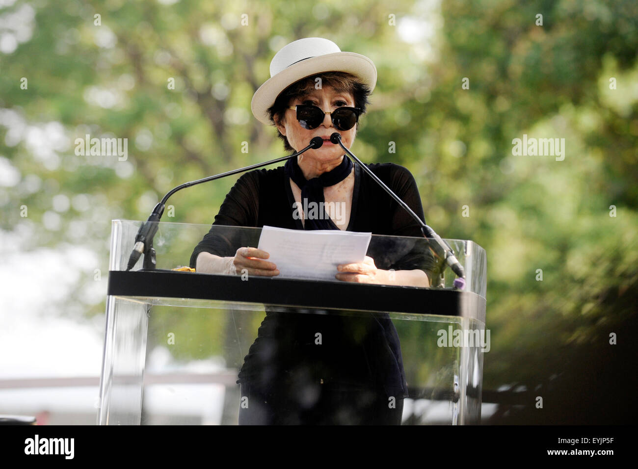 La città di New York. 29 Luglio, 2015. Yoko Ono parla di Amnesty International arazzo in onore di John Lennon scoprimento ad Ellis Island il 29 luglio 2015 in New York City./picture alliance © dpa/Alamy Live News Foto Stock