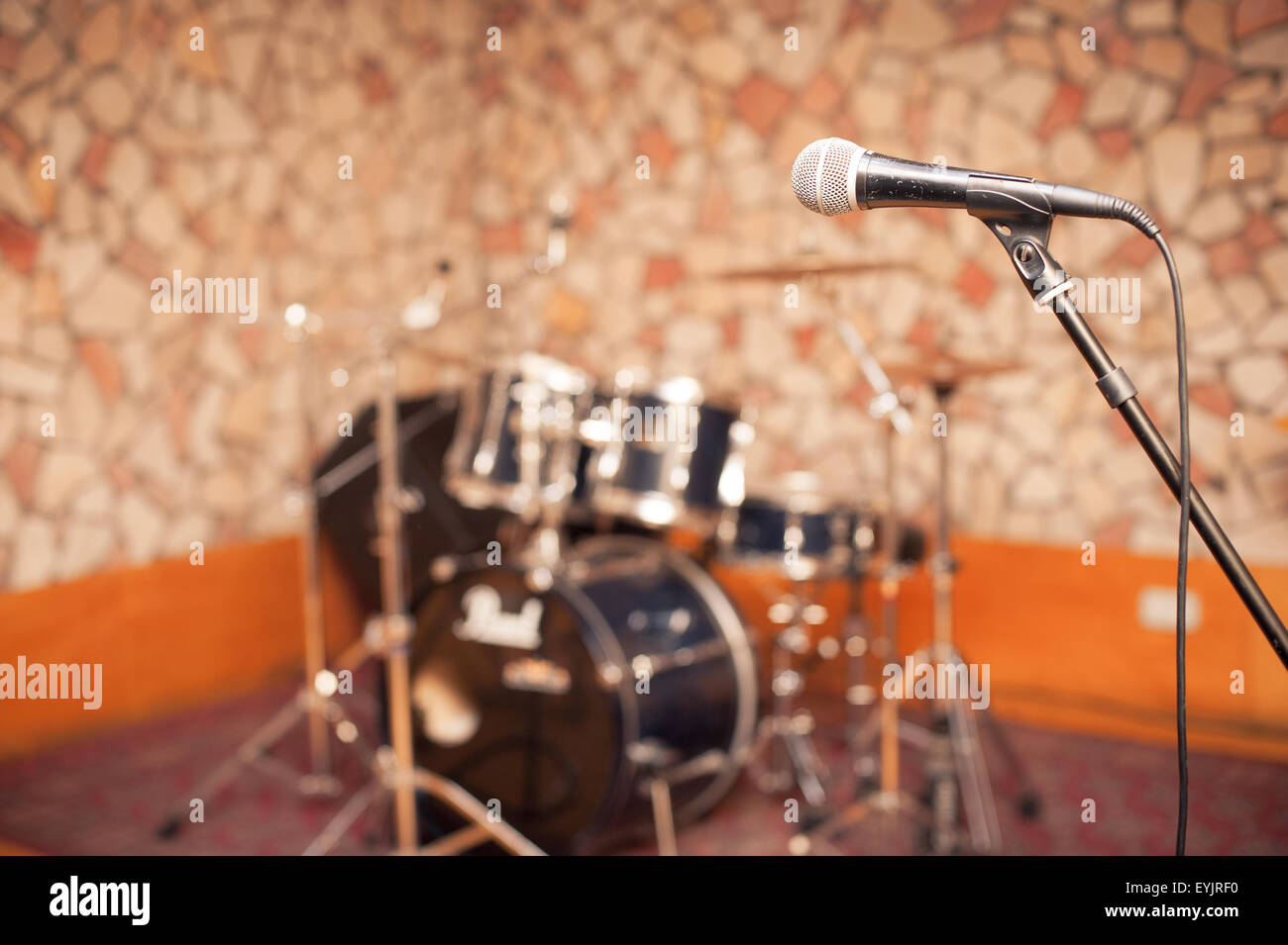 Microfono in music studio, stadio con fuori fuoco tamburi in background  Foto stock - Alamy