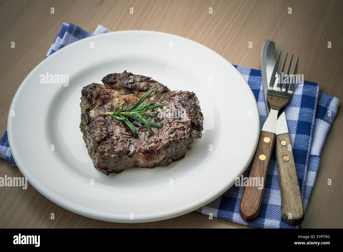 Succose grigliate costata di manzo con posate, vista dall'alto, uno stile rétro Foto Stock