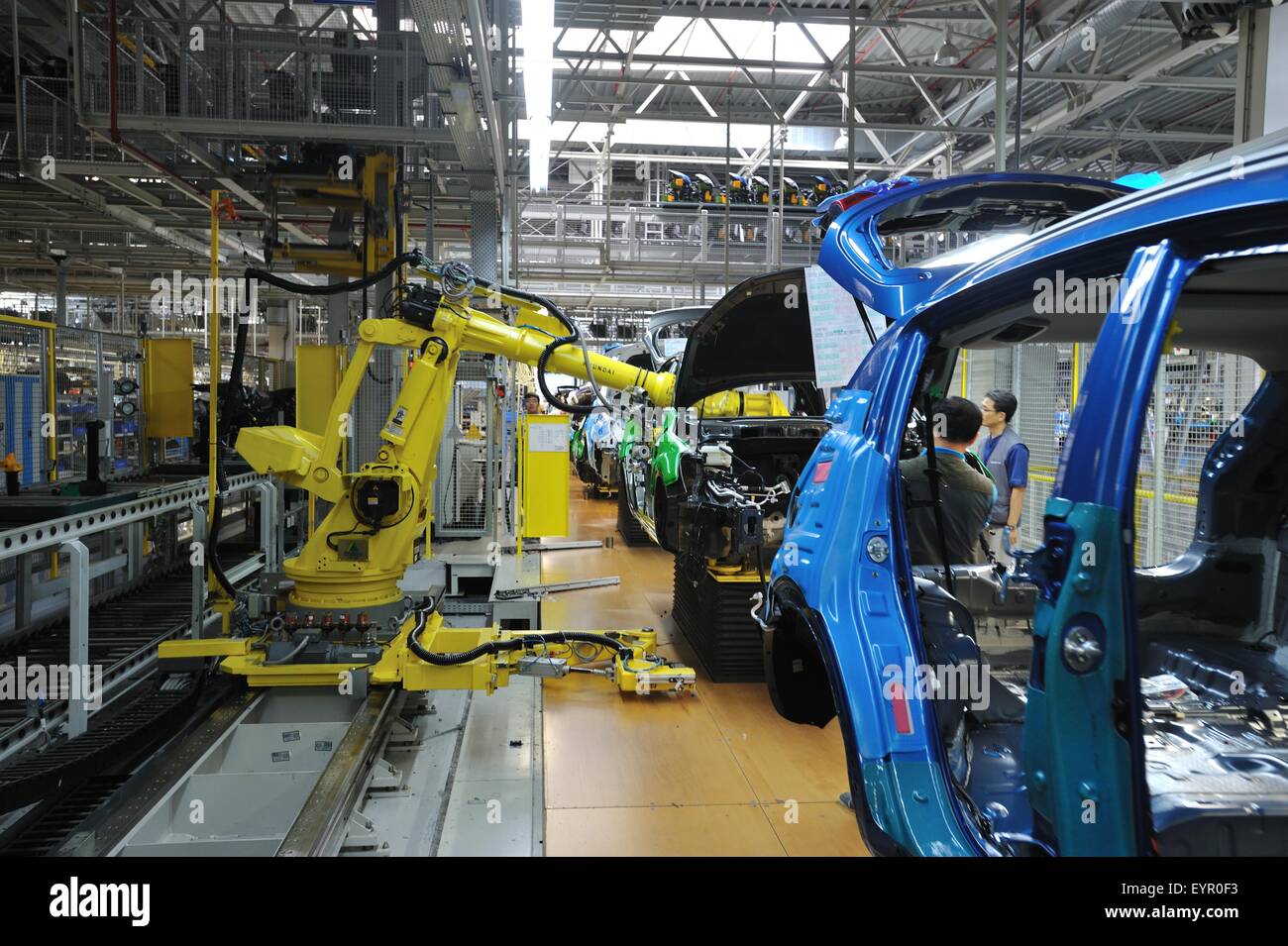 All'interno di una moderna fabbrica di automobili e veicoli e parti si muovono attraverso il processo di produzione, robot consentono di assemblare automobili Foto Stock