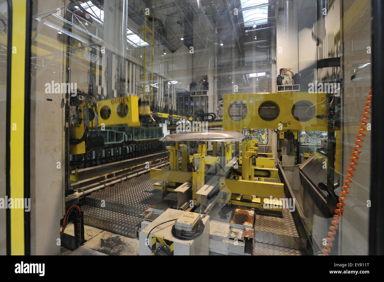 All'interno di una moderna fabbrica di automobili e veicoli e parti si muovono attraverso il processo di produzione, stampigliatura macchina taglia fuori le parti Foto Stock