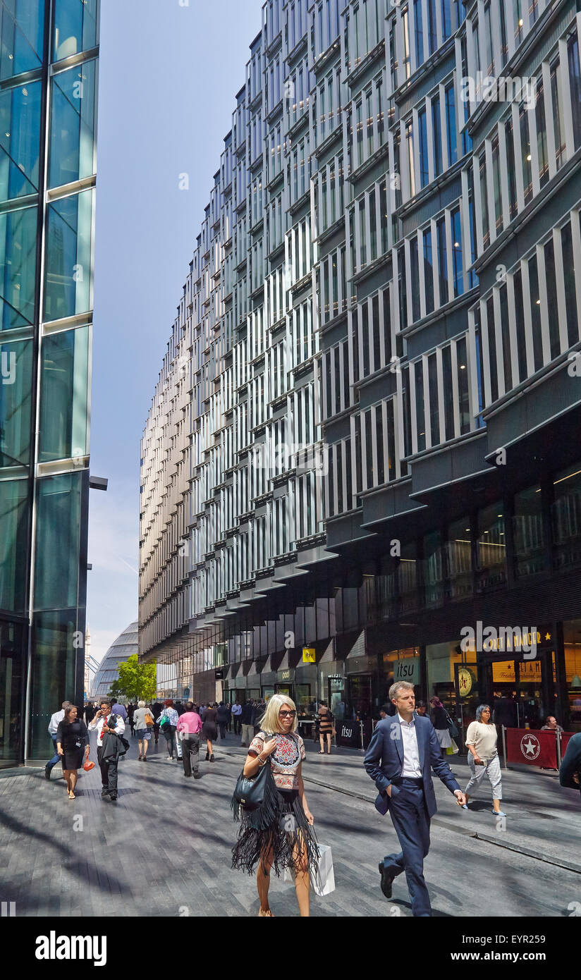Uomini e donne camminare accanto a edifici per uffici Foto Stock