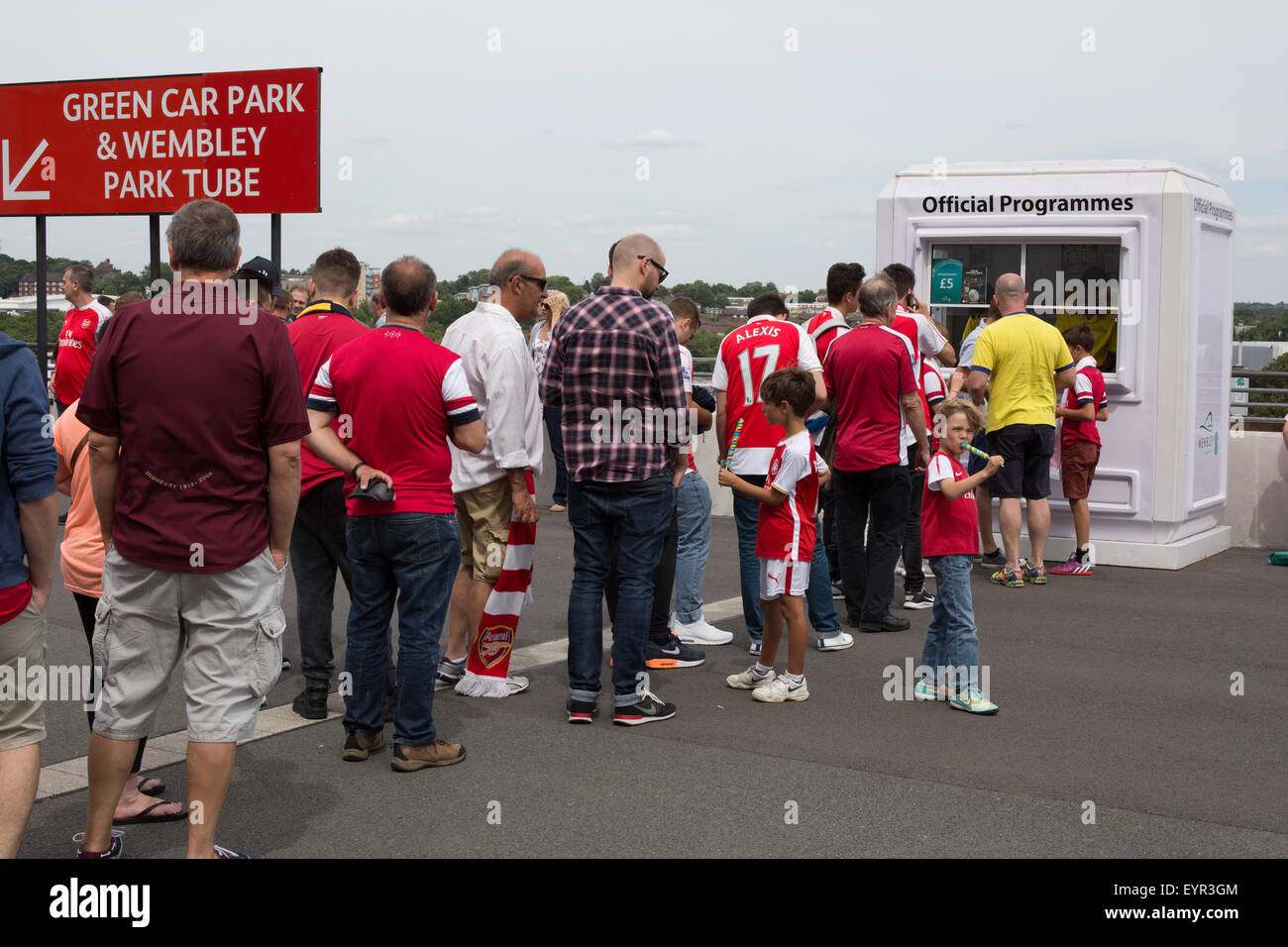 Arsenal Football Supporters in coda per acquistare programmi ufficiali Foto Stock