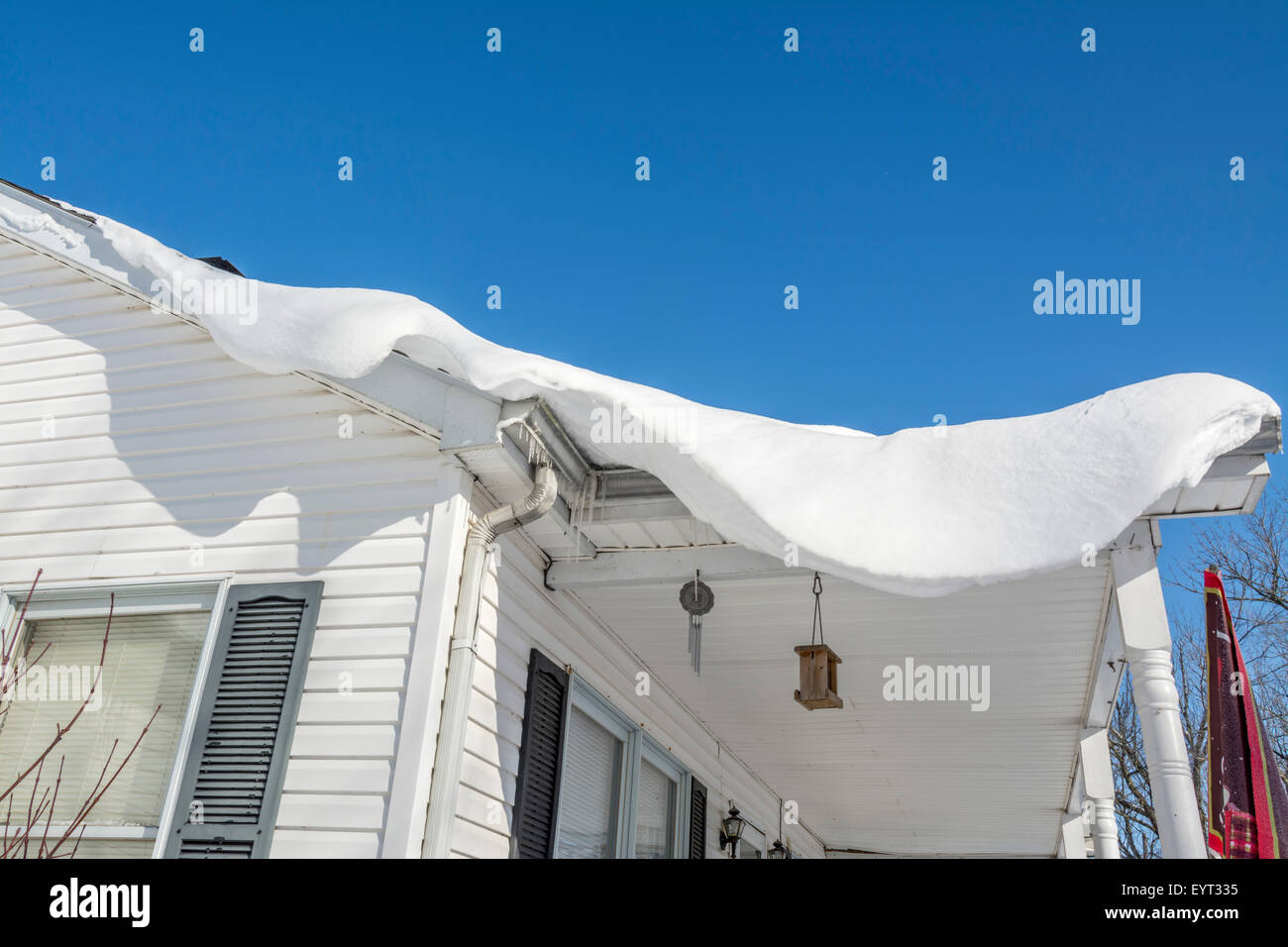 Deep Snow Drift a strapiombo sul tetto di una casa Foto Stock