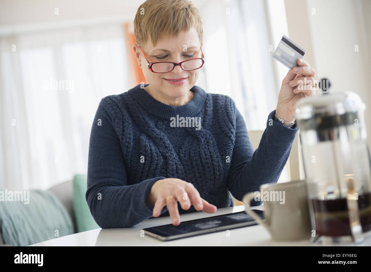 La donna caucasica shopping online su tavoletta digitale Foto Stock
