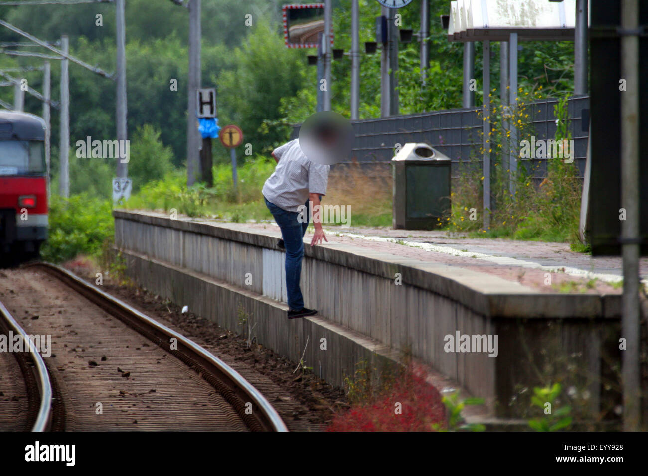 L'uomo attraversando i binari ferroviari a rischio della propria vita, Germania Foto Stock