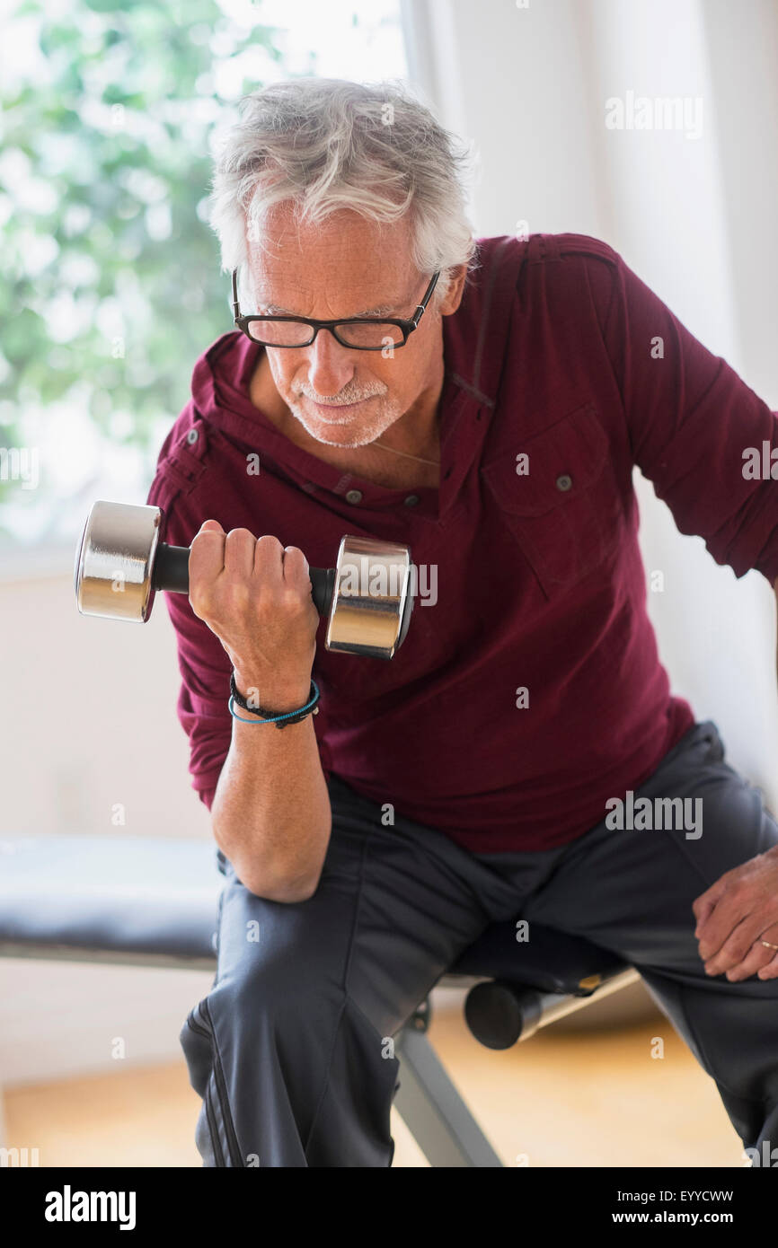 Vecchio uomo caucasico sollevamento pesi nella palestra Foto Stock