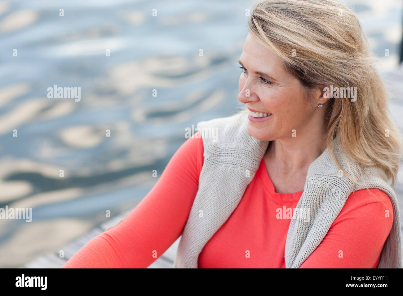 Sorridente donna caucasica canoa canottaggio sul lago Foto Stock