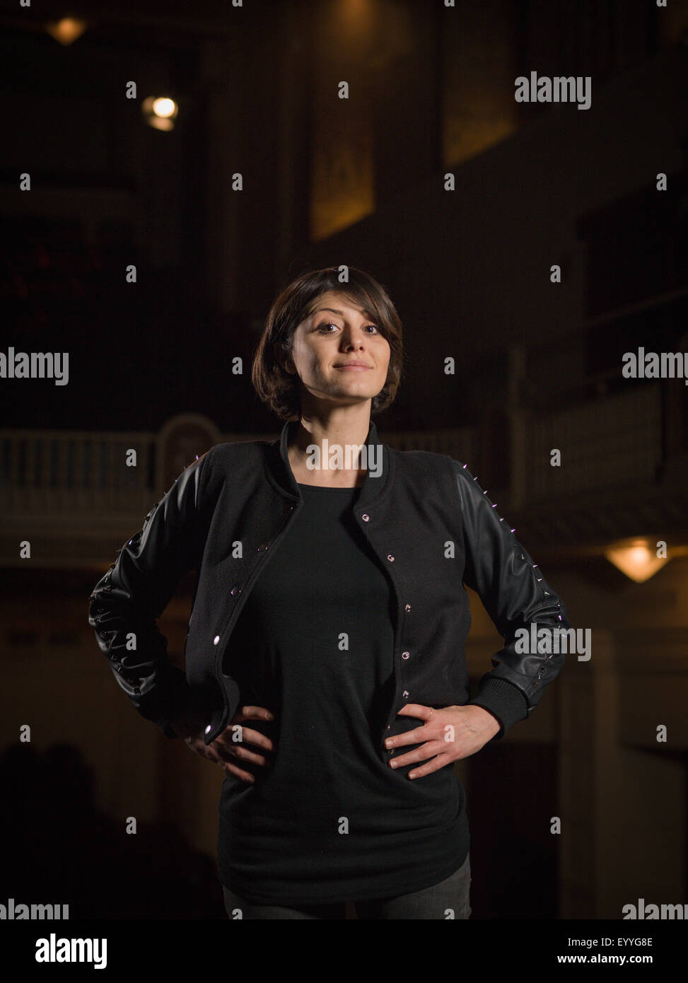 Caucasian woman standing in movie theater Foto Stock