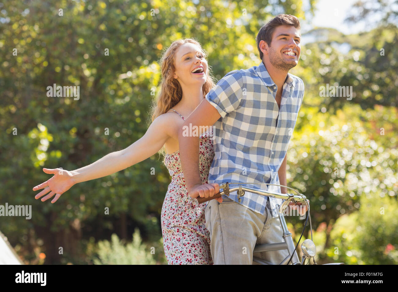 Una giovane coppia in un giro in bici nel Parco Foto Stock